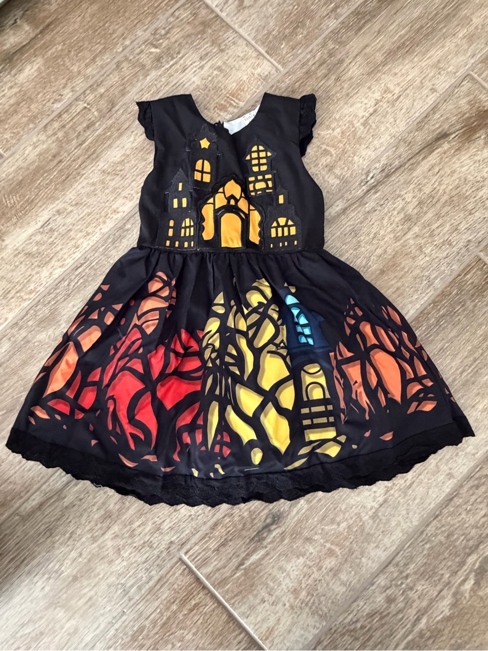 Taylor Black Castle Dress with Red Orange Yellow and Blue Accents